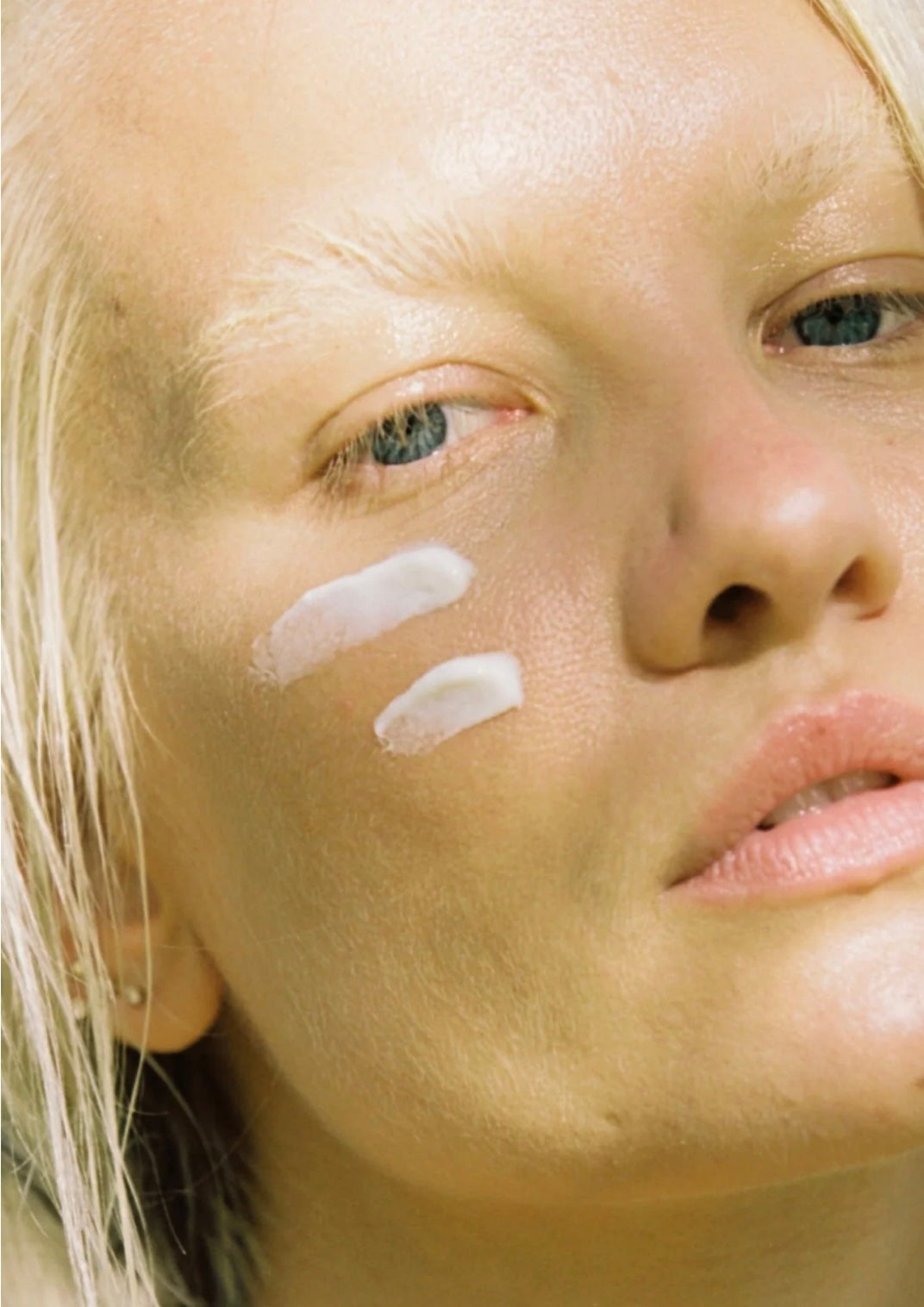 Woman resting outdoors in soft daylight for the Her Solis sunlight and SPF guide